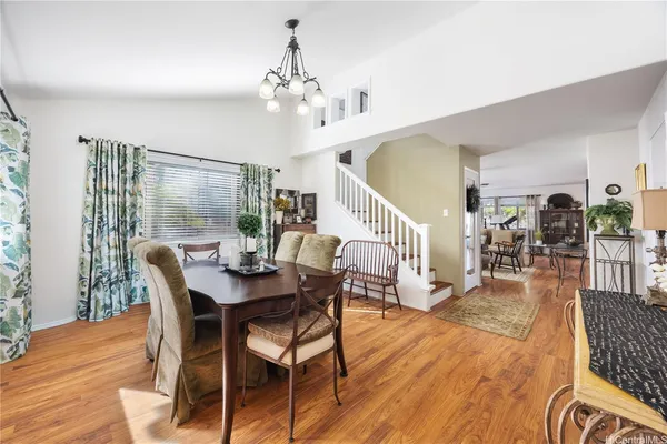 a view of a dining room with furniture wooden floor and chandelier