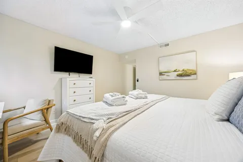 a bedroom with a bed and a flat screen tv