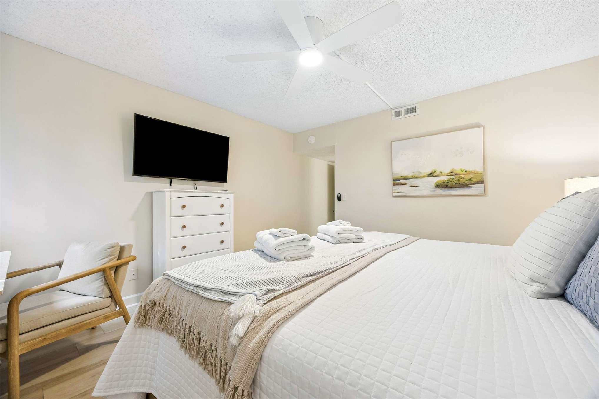 2014 Beachwood Road, Unit 2014 Amelia Island, FL 32034 - Photo 16 of 36 a bedroom with a bed and a flat screen tv