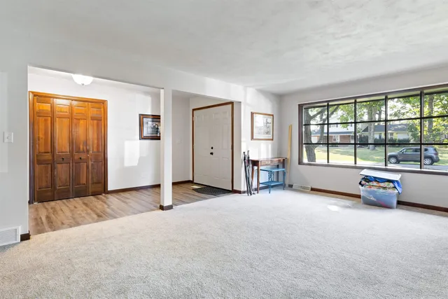 an empty room with windows and view of balcony