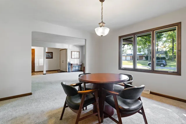 a dining room with furniture and window