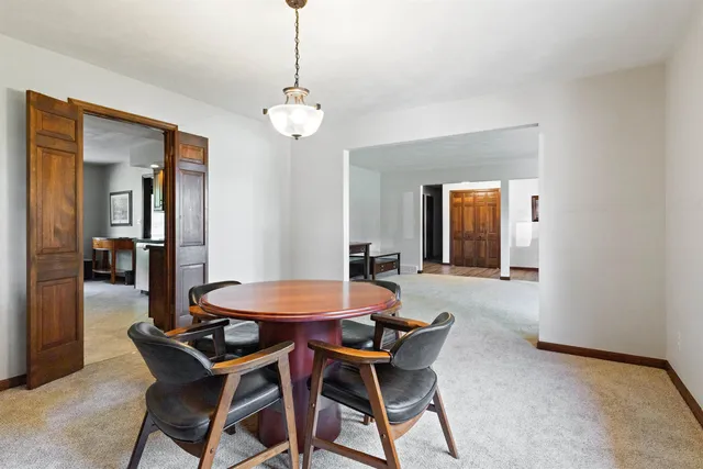 a dining room with furniture and window