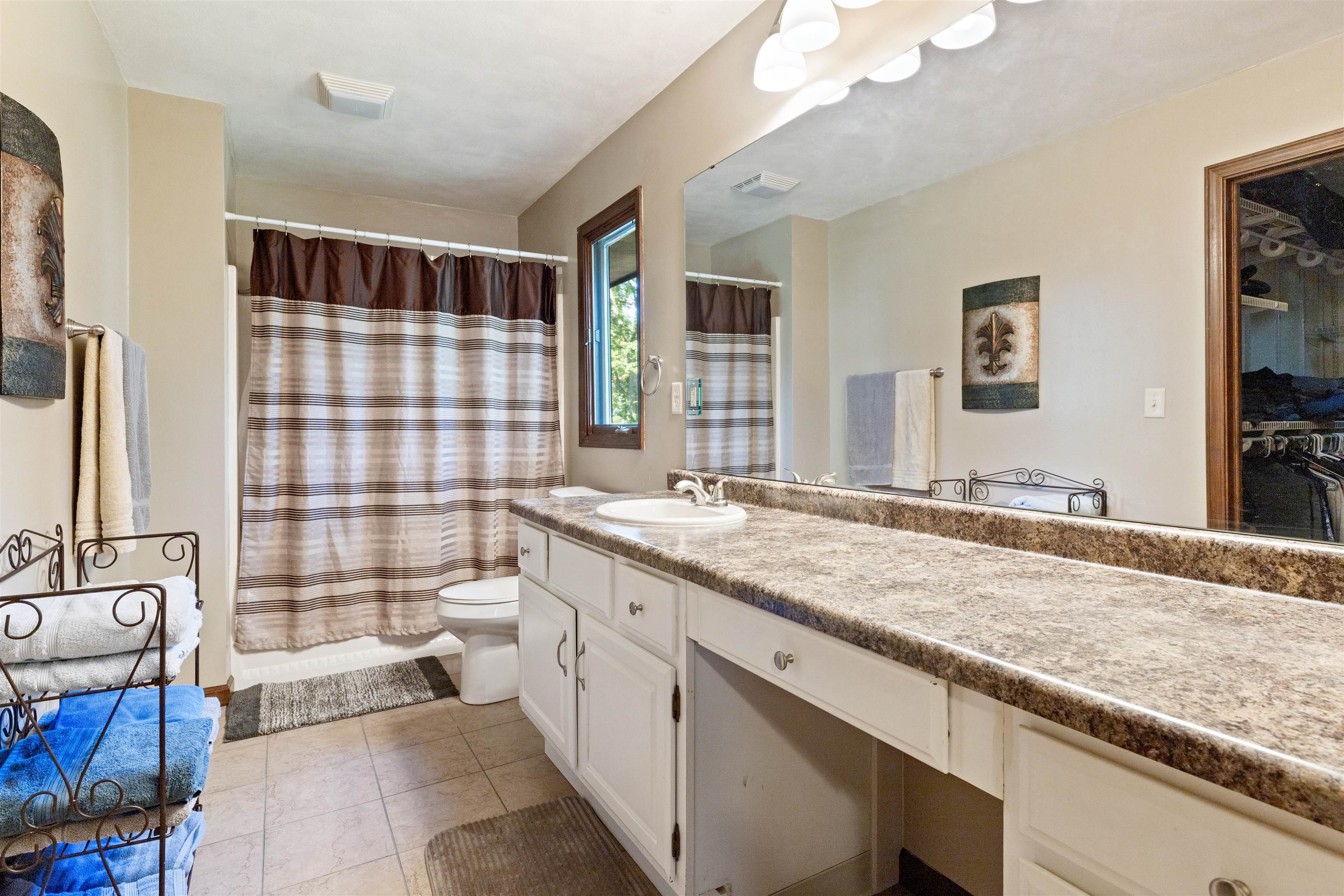 2518 Mandrake Drive Rockford, IL 61108 - Photo 24 of 50 a spacious bathroom with a granite countertop double vanity sink a mirror and a bathtub