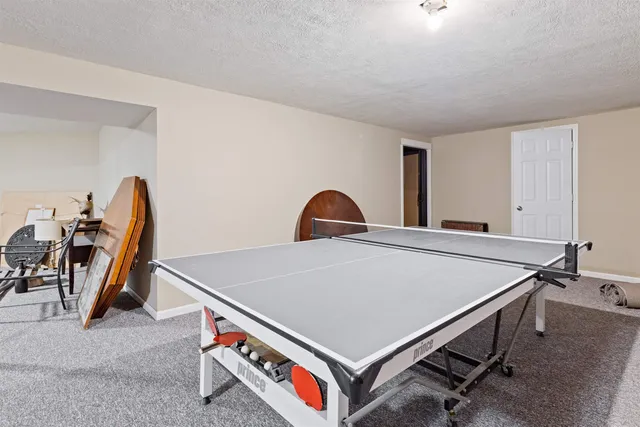 a room with pool table and windows
