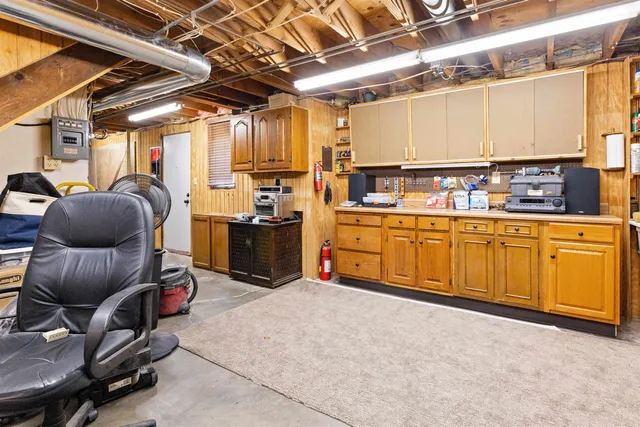 a room with stainless steel appliances kitchen island granite countertop lots of counter top space