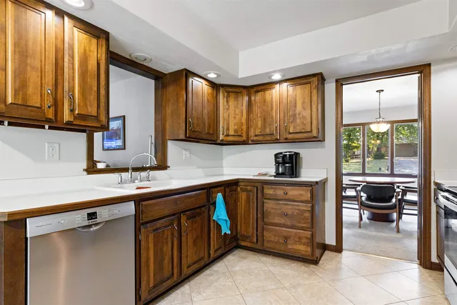 a kitchen with a sink window and cabinets