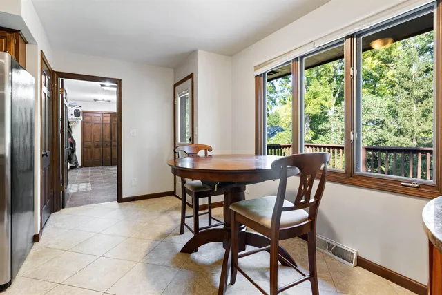 a view of a dining room with furniture and a window