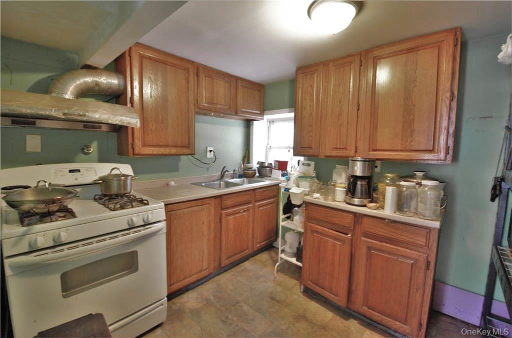 16 Woodland Road Middletown, NY 10940 - Photo 8 of 13 a kitchen with granite countertop cabinets stainless steel appliances and a sink