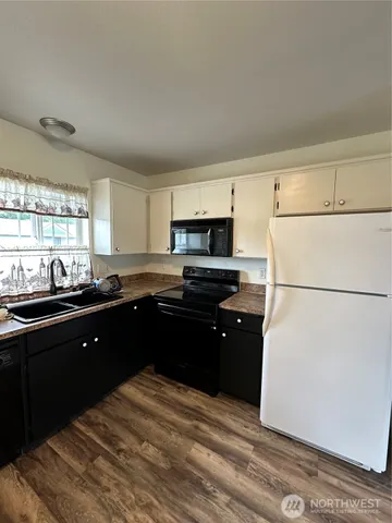 a kitchen with a refrigerator and a sink