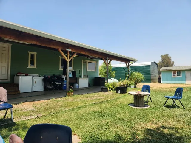 a view of a house with backyard porch and sitting area