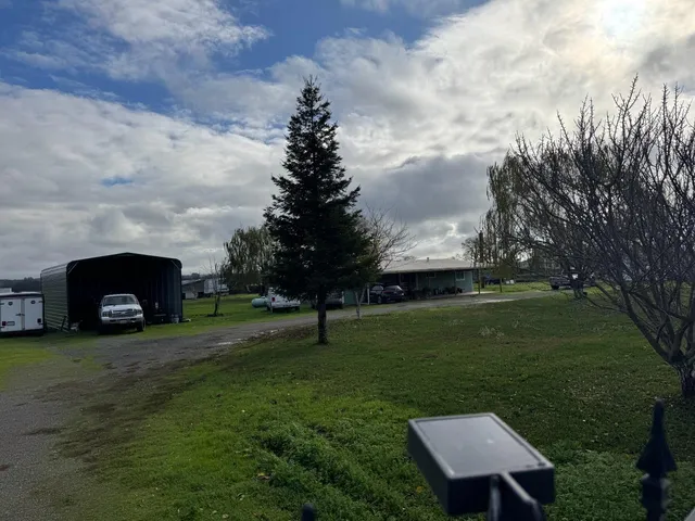 a backyard of a house with table and chairs