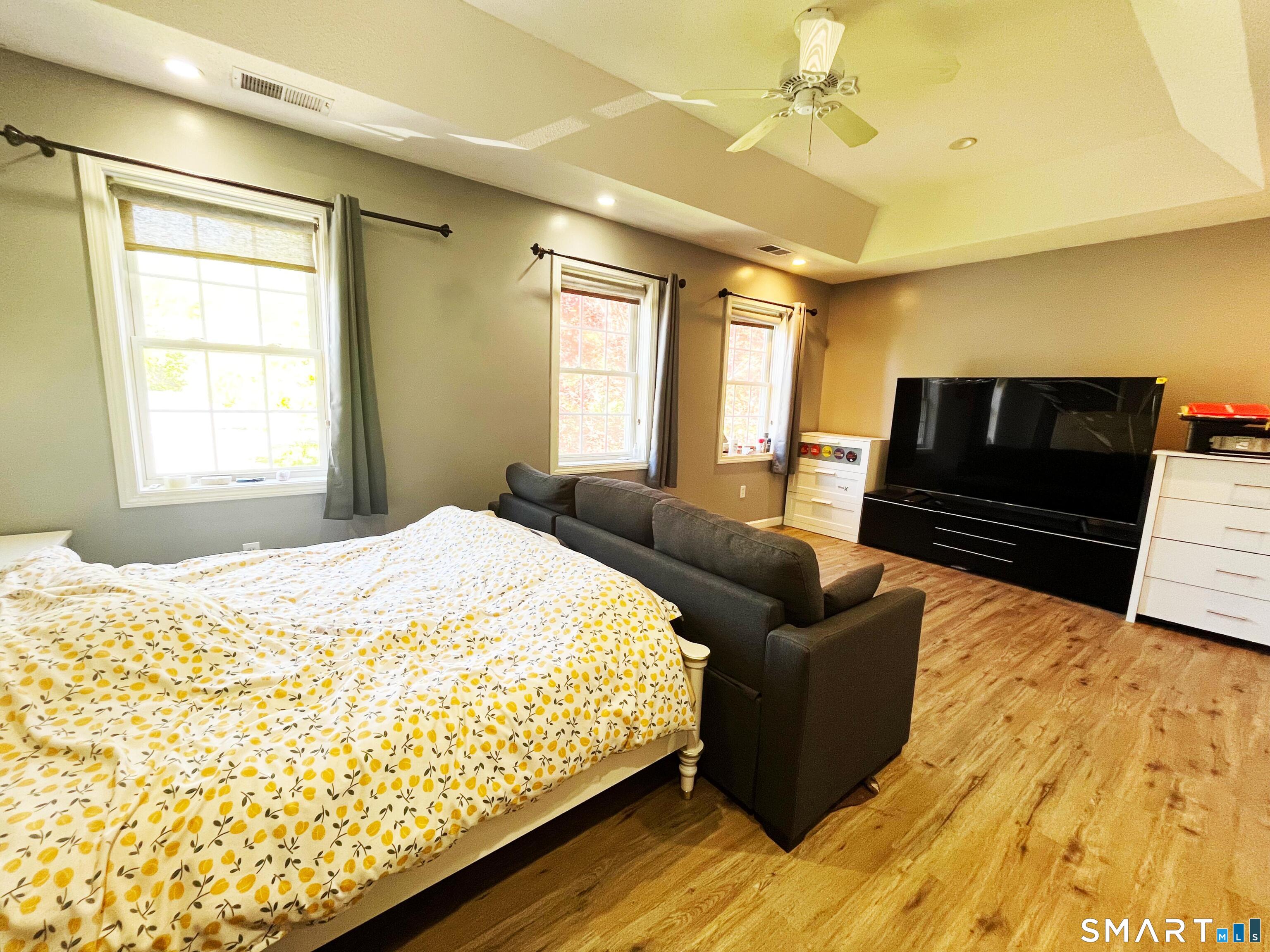 52 Monce Road Burlington, CT 06013 - Photo 6 of 26 a bedroom with a bed and wooden floor