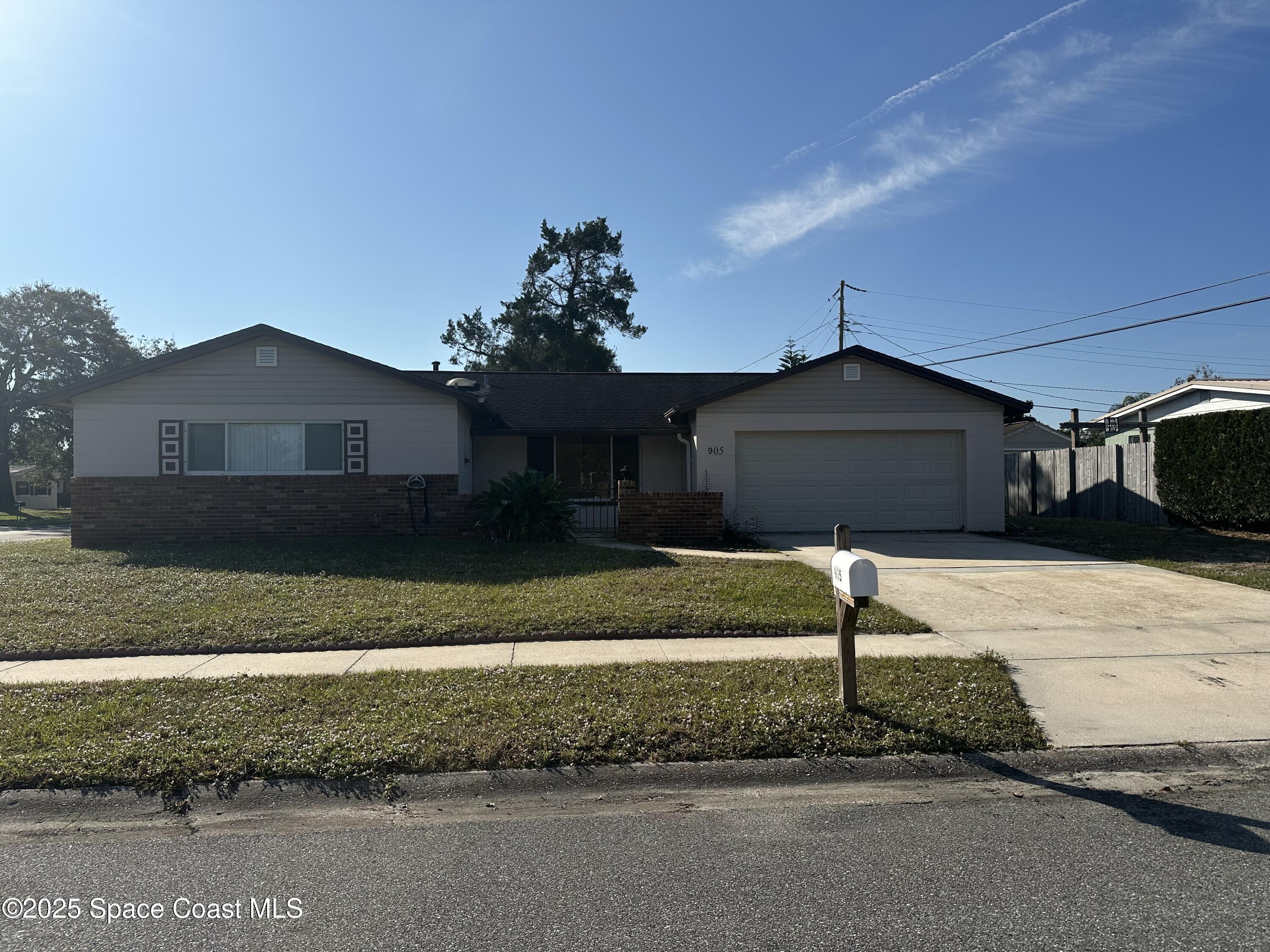 905 Grant Road Titusville, FL 32780 - Photo 1 of 30 a front view of a house with a yard