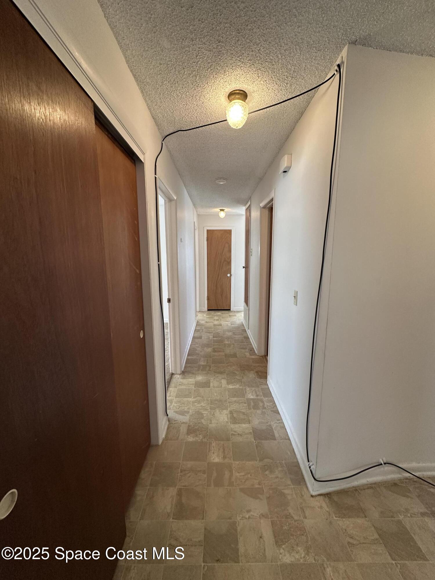905 Grant Road Titusville, FL 32780 - Photo 12 of 30 a view of a hallway with painted walls