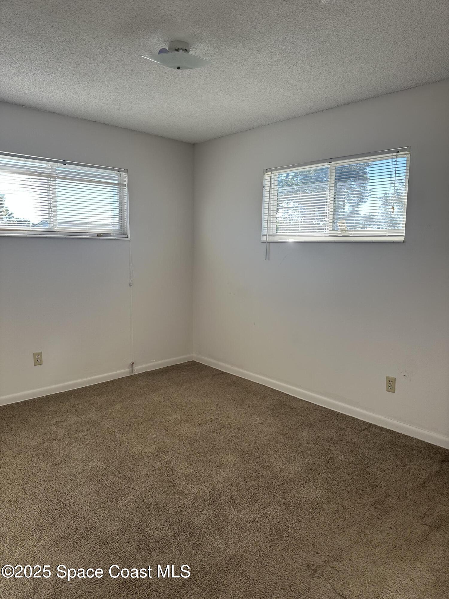 905 Grant Road Titusville, FL 32780 - Photo 14 of 30 an empty room with a workbench