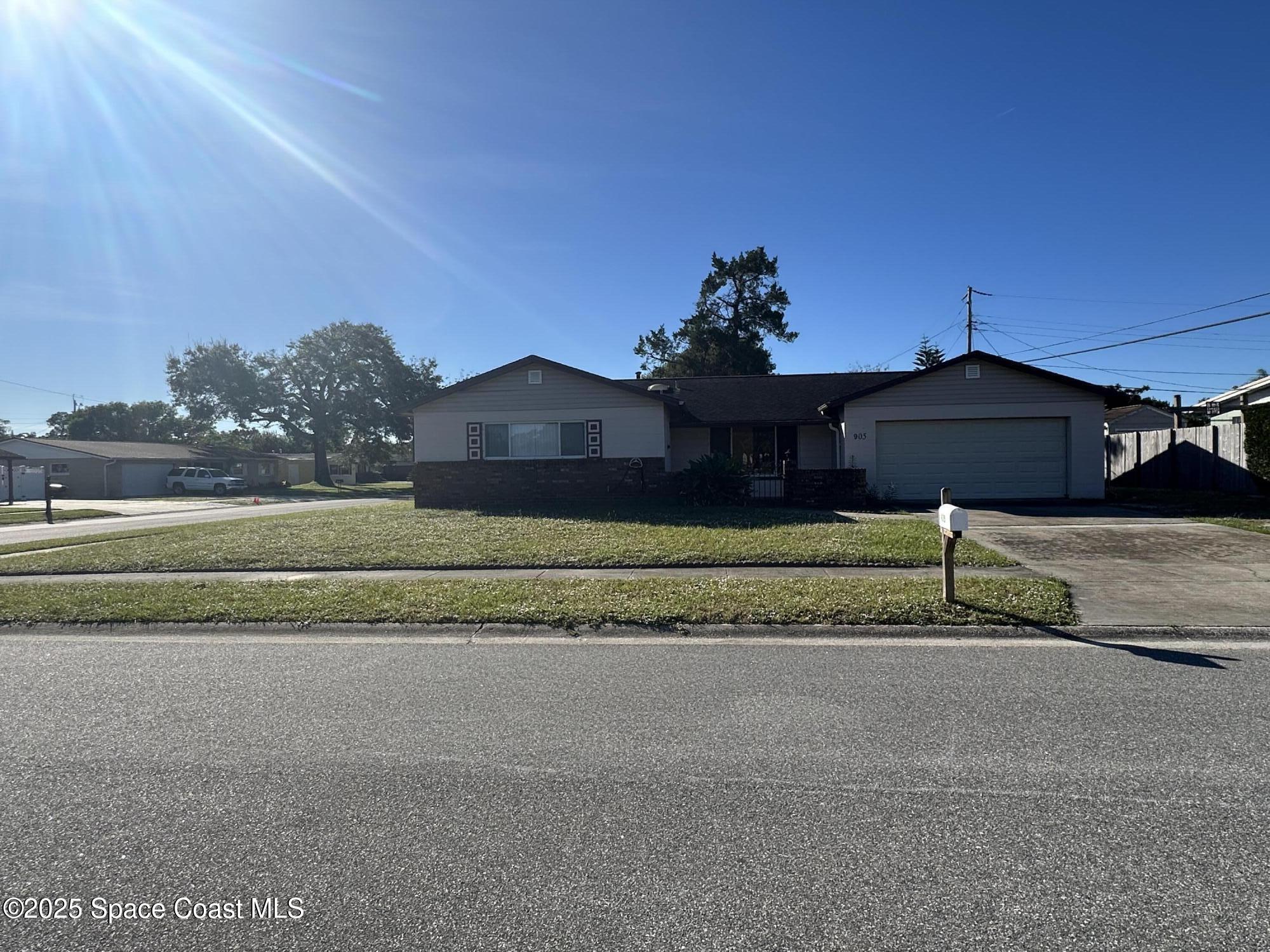 905 Grant Road Titusville, FL 32780 - Photo 2 of 30 a house with a yard