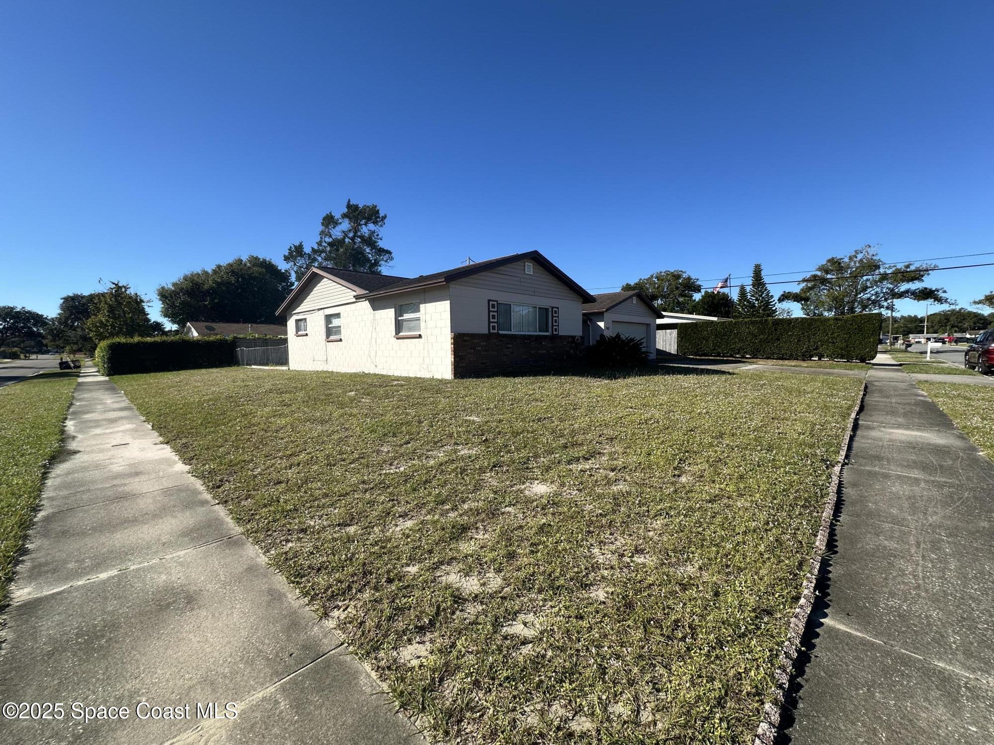 905 Grant Road Titusville, FL 32780 - Photo 27 of 30 a view of a house with a yard