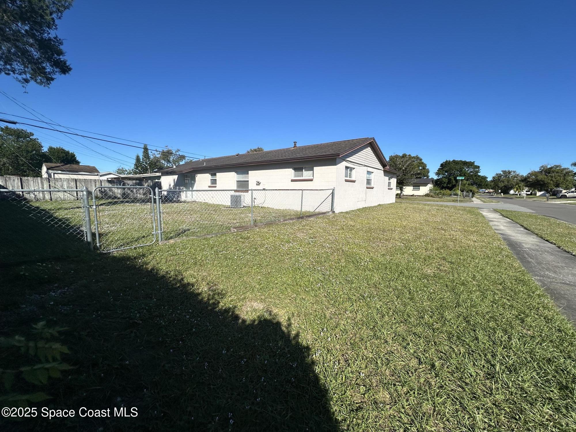 905 Grant Road Titusville, FL 32780 - Photo 28 of 30 a view of a big yard next to a building