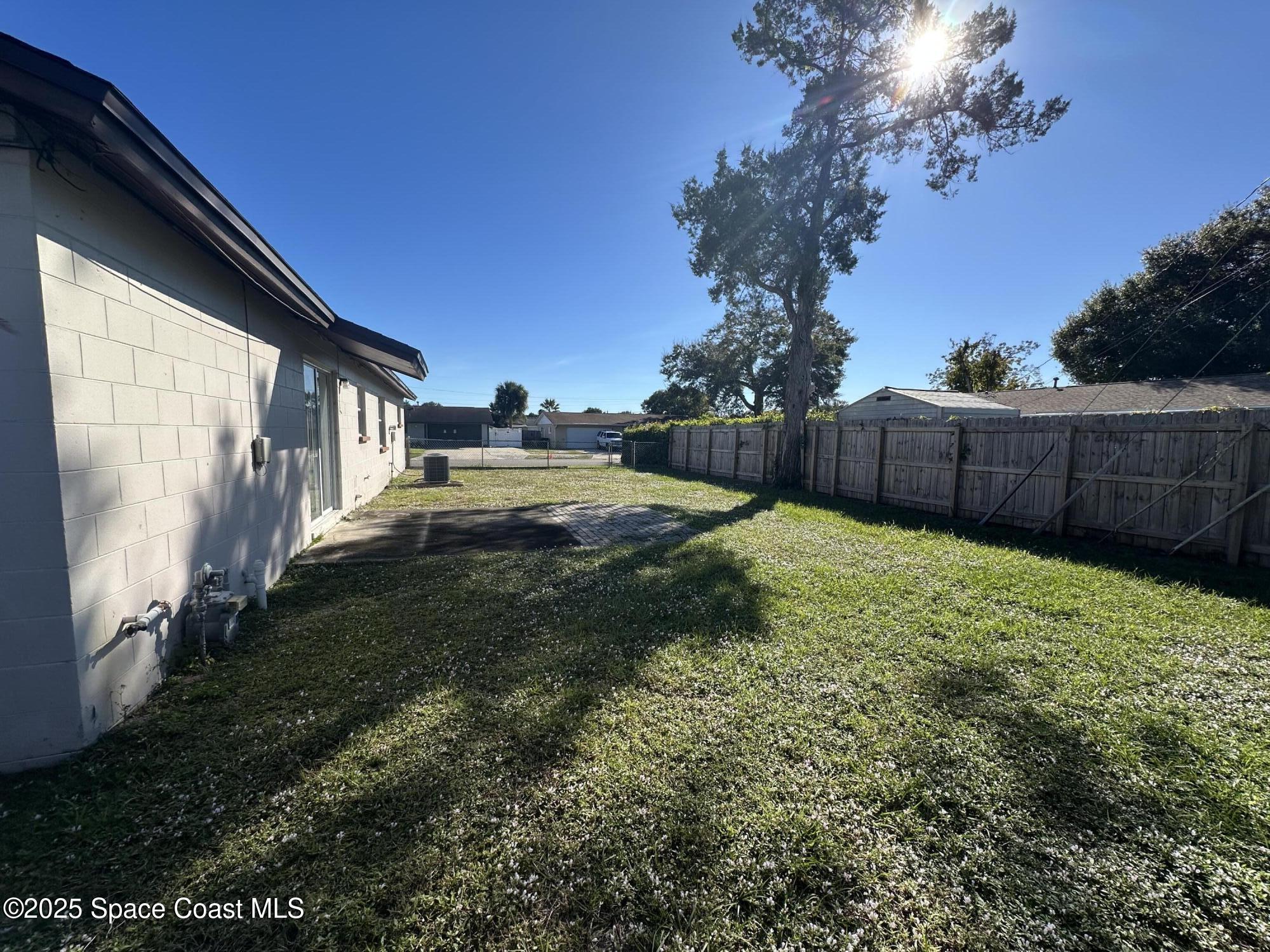 905 Grant Road Titusville, FL 32780 - Photo 29 of 30 a view of backyard with garden and trees