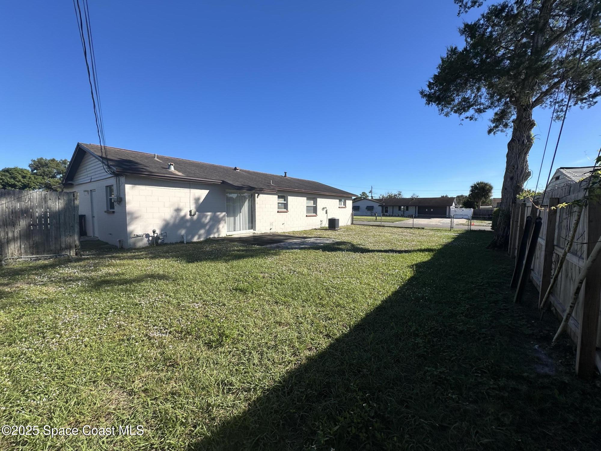 905 Grant Road Titusville, FL 32780 - Photo 30 of 30 a view of an house next to a yard and deck