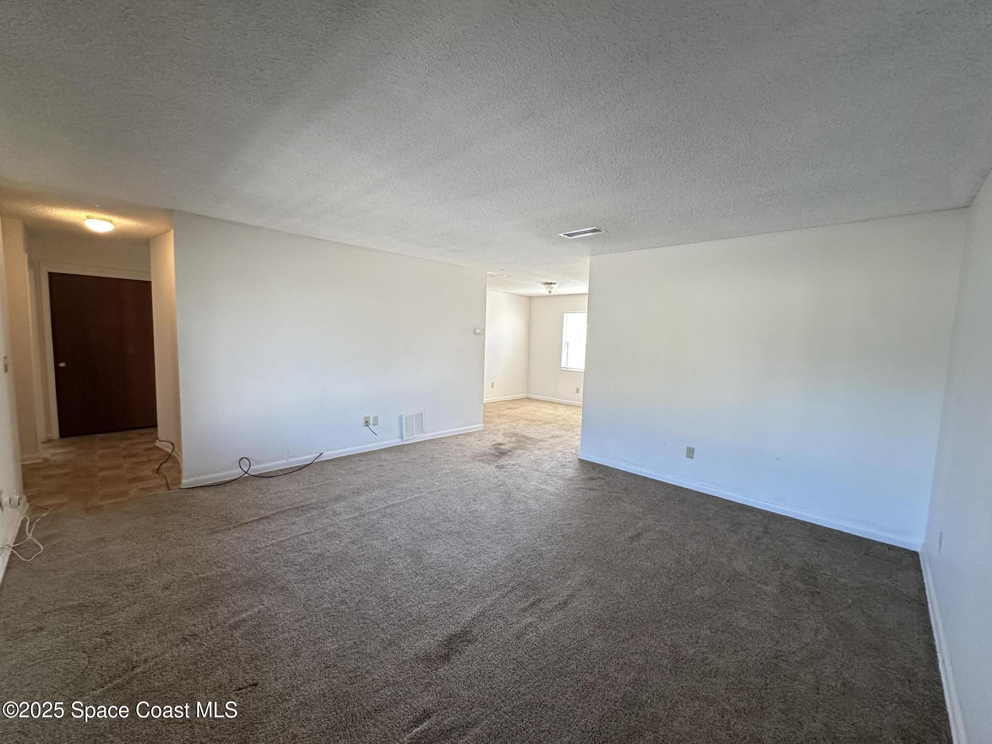 905 Grant Road Titusville, FL 32780 - Photo 5 of 30 a view of an empty room and window