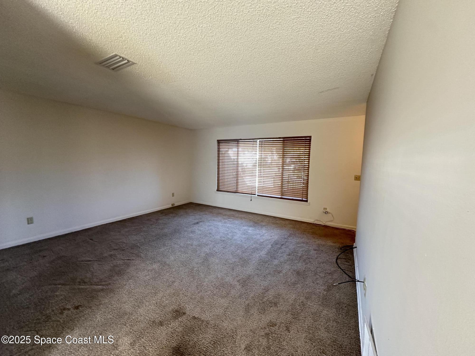 905 Grant Road Titusville, FL 32780 - Photo 7 of 30 an empty room with windows