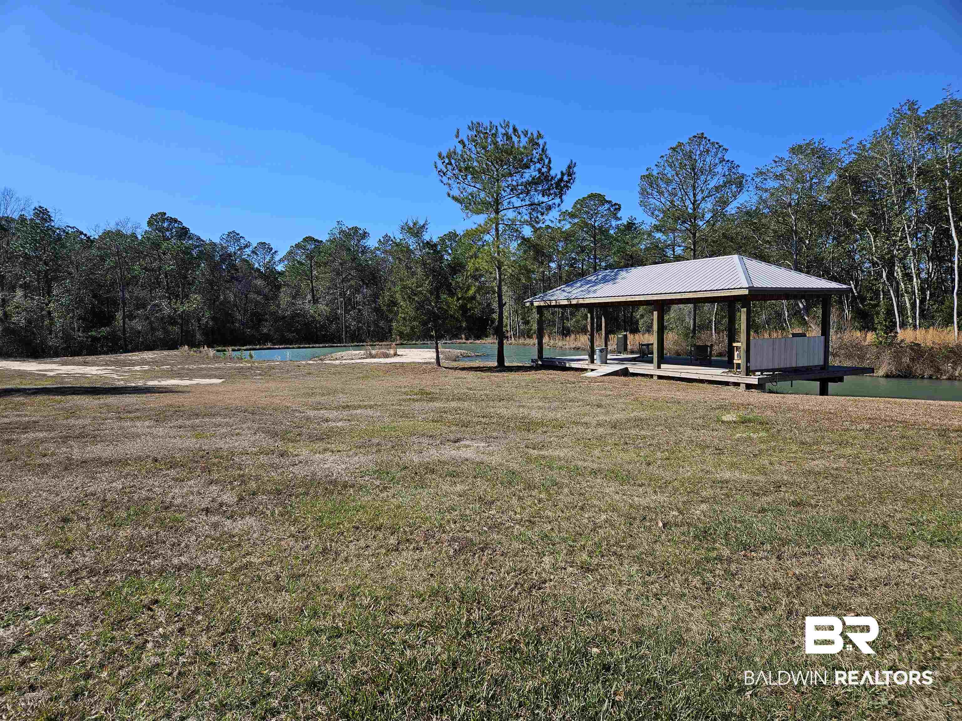 20125 Matthews Way Silverhill, AL 36576 - Photo 2 of 4 View of green lawn with an outdoor pool and a patio