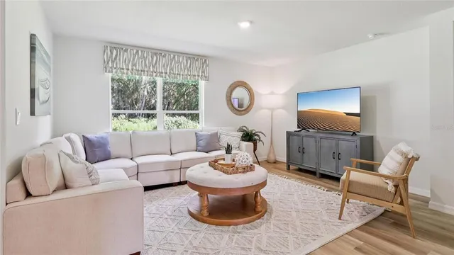 a living room with furniture and a large window