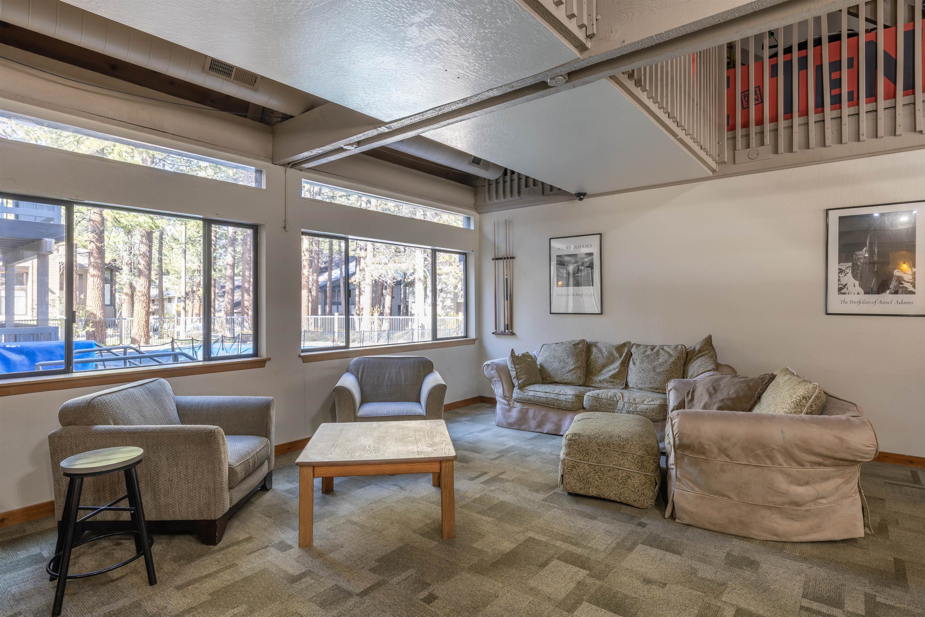 2252 Meridian Boulevard, Unit 32 Mammoth Lakes, CA 93546 - Photo 31 of 31 Carpeted living room with baseboards and a high ceiling