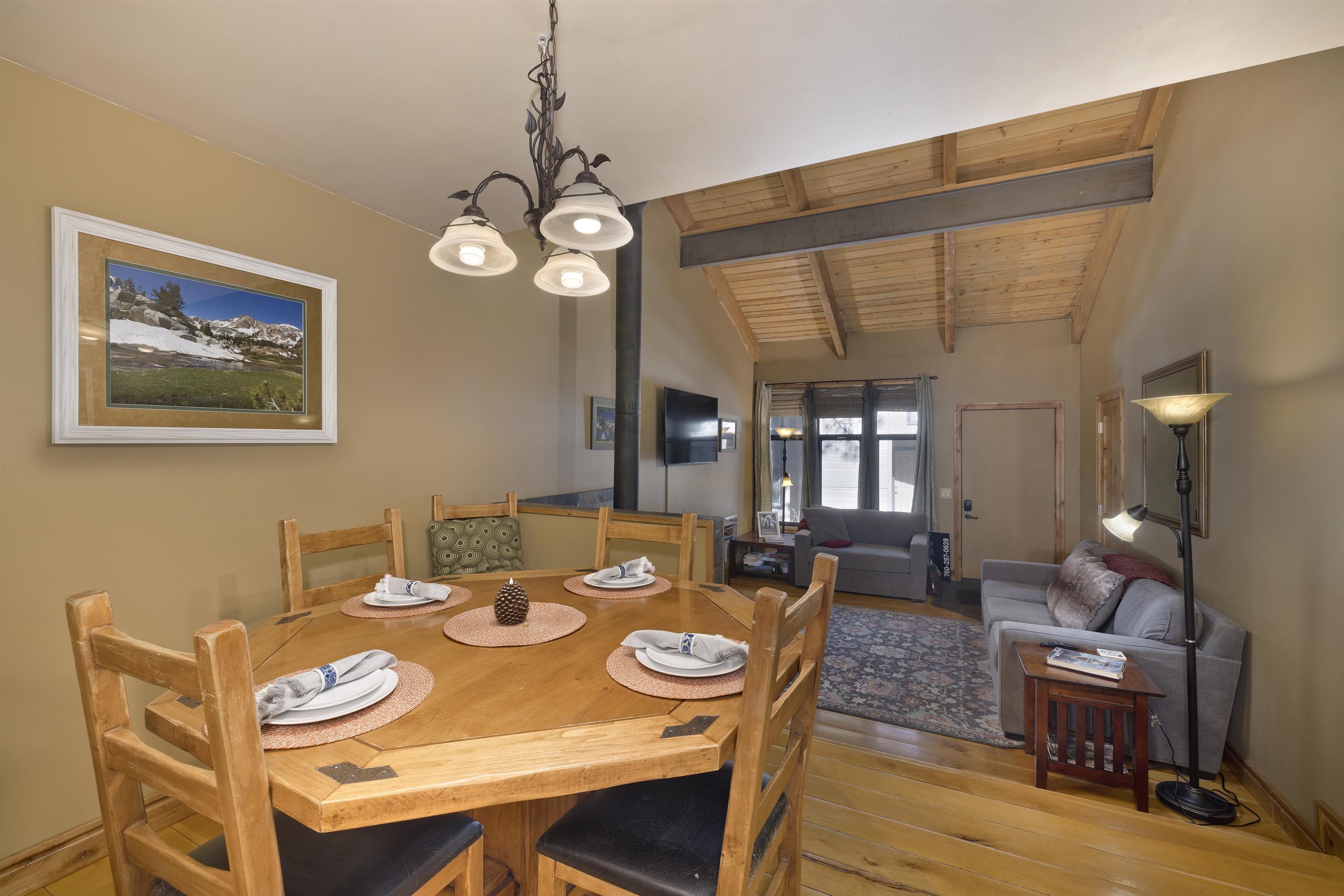 2252 Meridian Boulevard, Unit 32 Mammoth Lakes, CA 93546 - Photo 6 of 31 Dining space with lofted ceiling with beams, light wood-style floors, wooden ceiling, and a chandelier