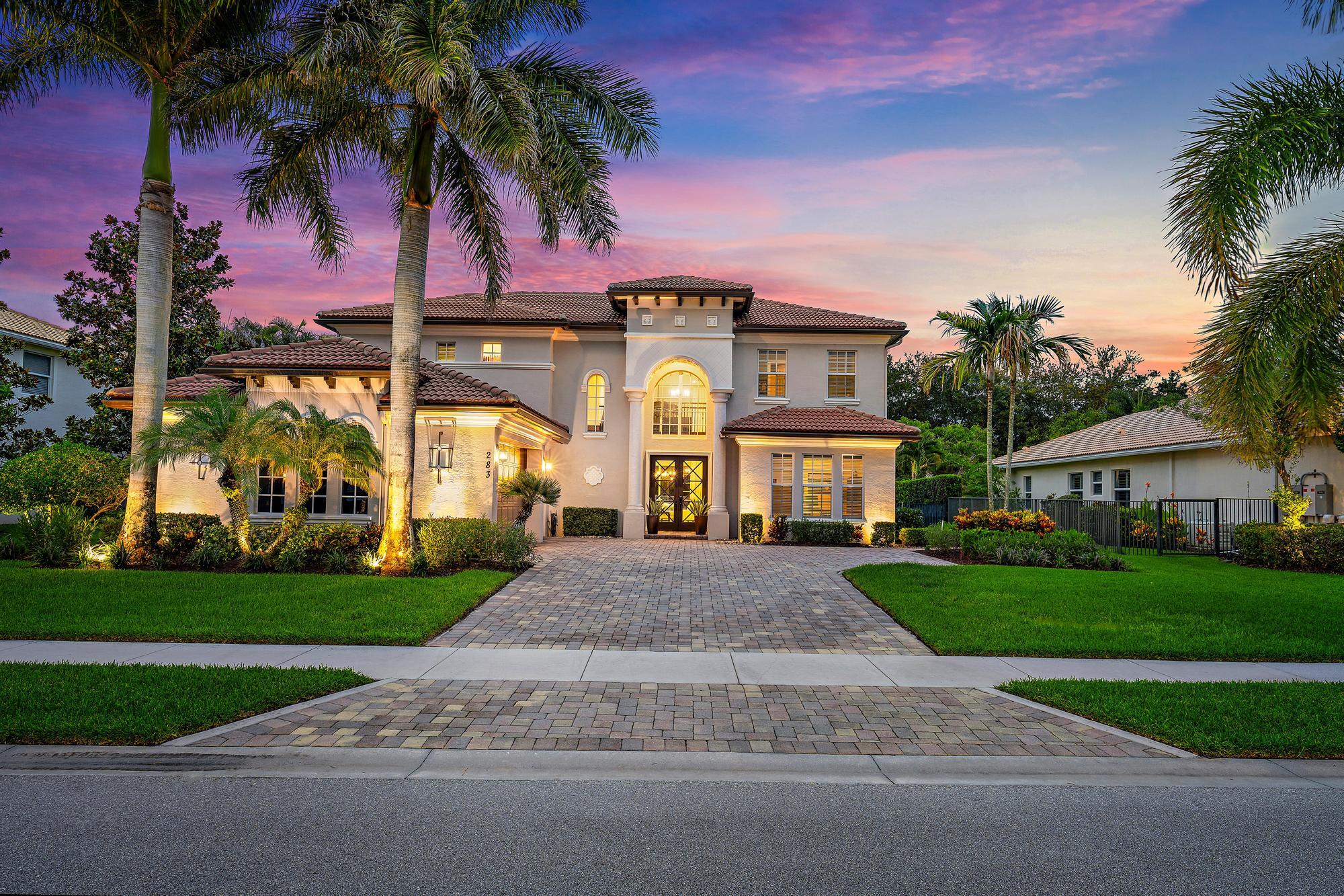 283 Rudder Cay Way Jupiter, FL 33458 - Photo 16 of 41 front view of a house with a yard and palm trees