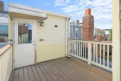 a view of balcony with wooden floor