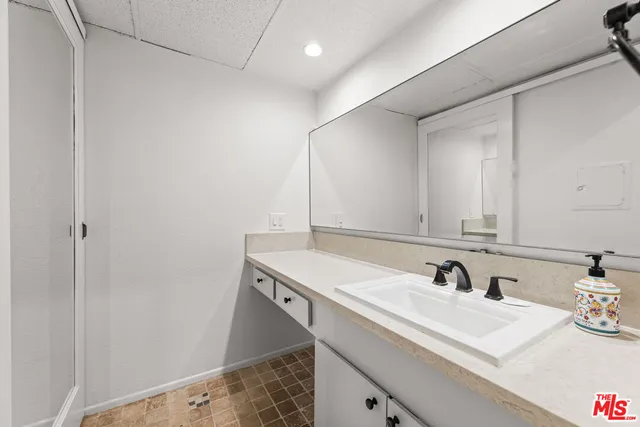 a bathroom with a sink and a mirror