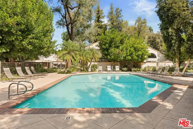 a view of a swimming pool with an outdoor seating