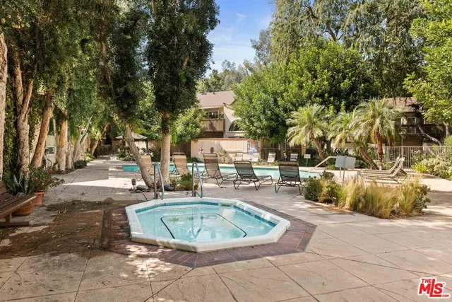 a view of a swimming pool with sitting area