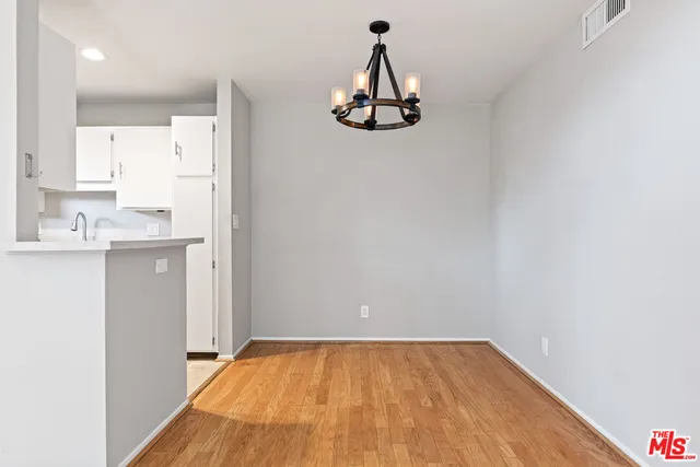 a view of a room with a sink and cabinets