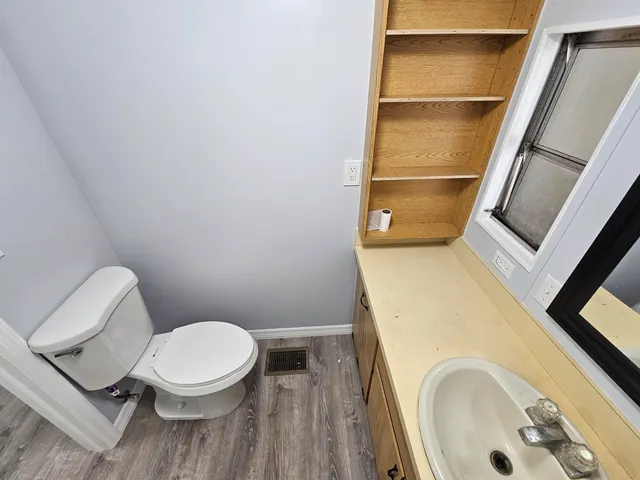 a white toilet sitting next to a tub