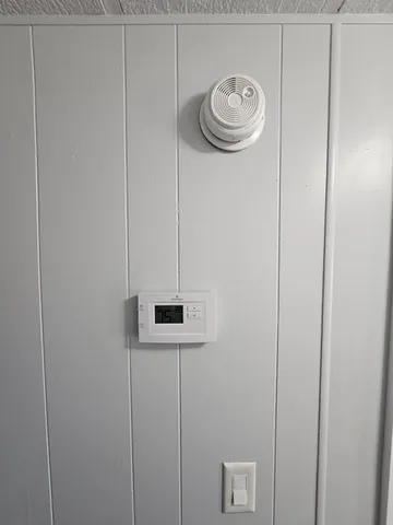 a view of a hallway with a rack on the wall