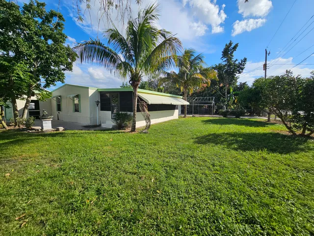 a view of yard with swimming pool and green space
