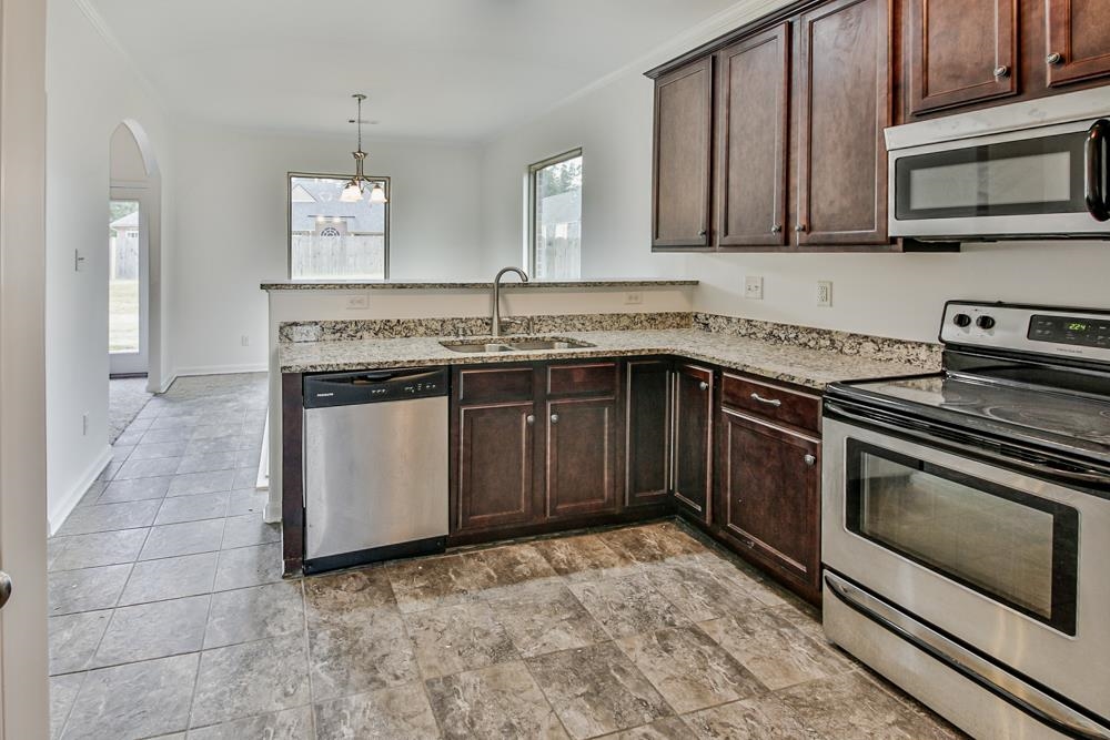 6839 Hare Pointe Bartlett, TN 38002 - Photo 11 of 35 a kitchen with a stove and a sink