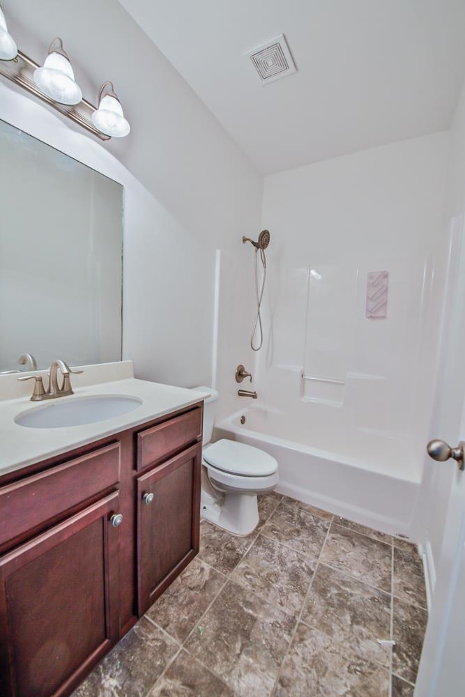 6839 Hare Pointe Bartlett, TN 38002 - Photo 22 of 35 a bathroom with a granite countertop toilet a sink and bathtub