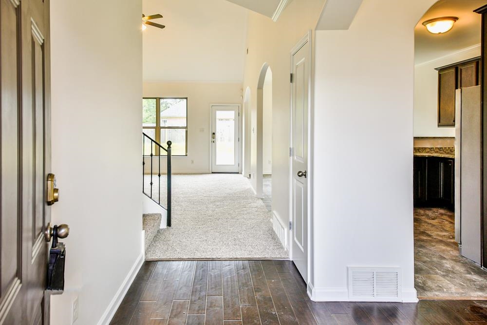 6839 Hare Pointe Bartlett, TN 38002 - Photo 5 of 35 a view of a hallway with wooden floor and staircase