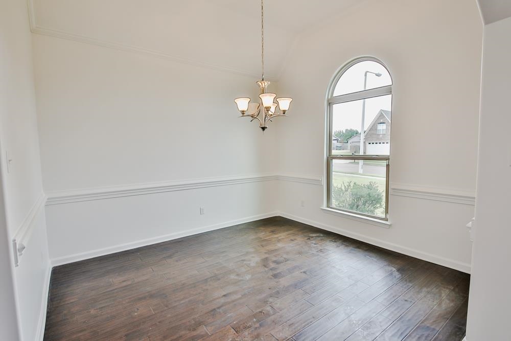 6839 Hare Pointe Bartlett, TN 38002 - Photo 6 of 35 wooden floor in an empty room with a window