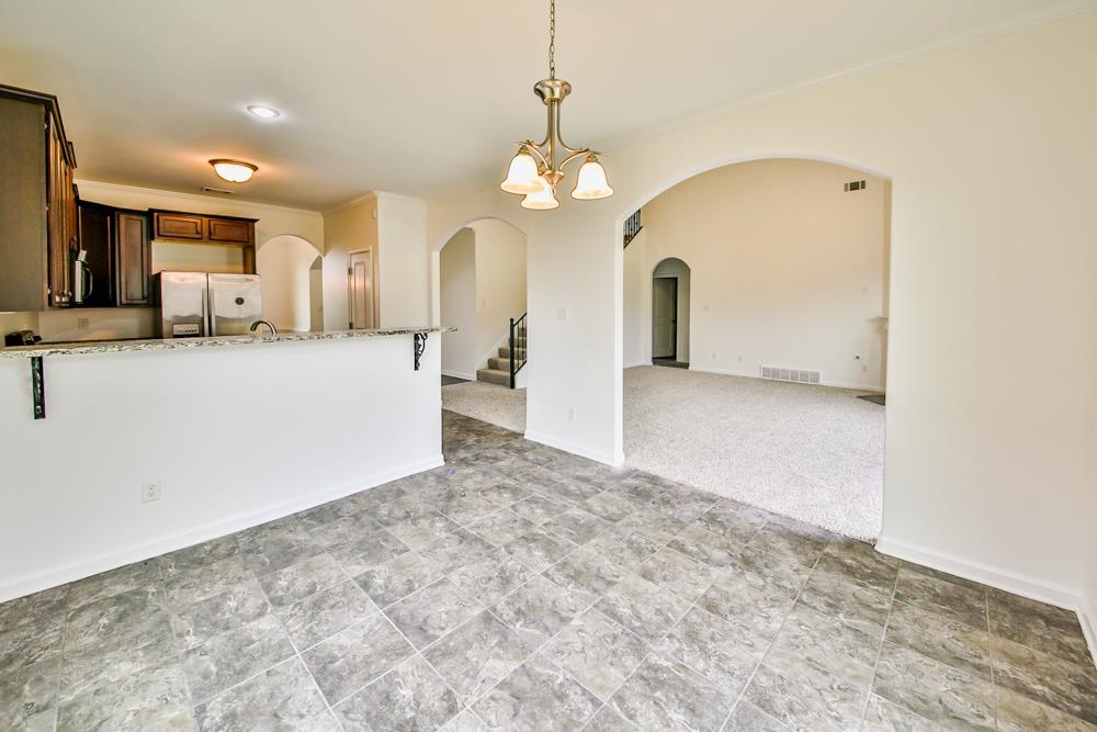 6839 Hare Pointe Bartlett, TN 38002 - Photo 10 of 35 a view of a kitchen with a sink and a chandelier
