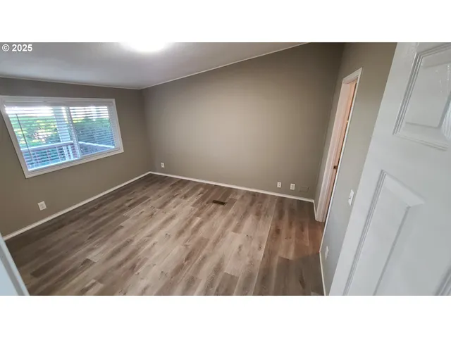 a kitchen with a sink a microwave a refrigerator and cabinets