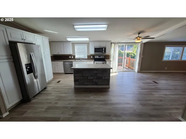 a kitchen with a sink and a refrigerator