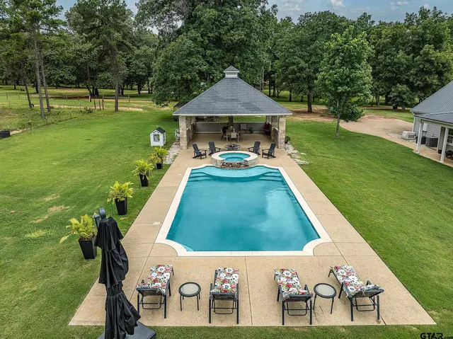 a view of a patio with table and chairs under an umbrella