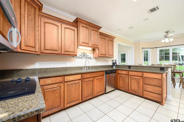 a kitchen with stainless steel appliances granite countertop a stove a sink and a refrigerator