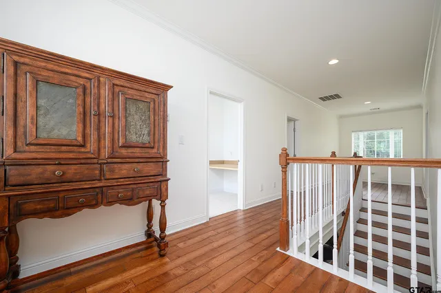 an empty room with windows and ceiling fan