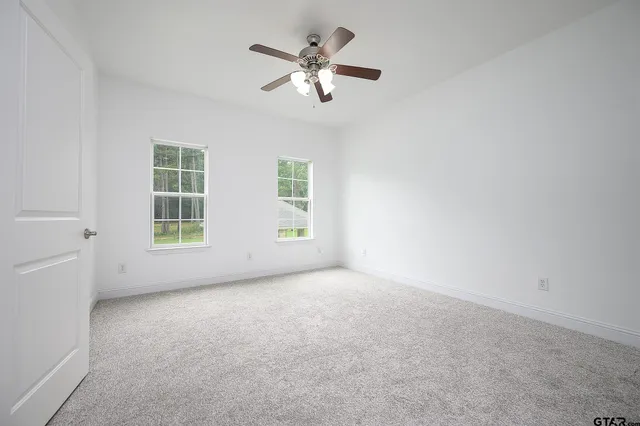a bathroom with a toilet a sink and a window